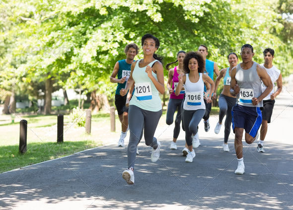 Group of marathon athletes running on street