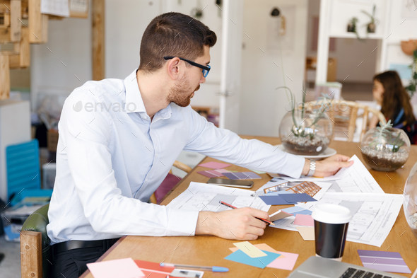 Young man in casual clothes in an office with drafts