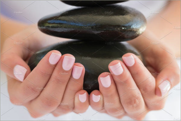 beauty therpist holding stones