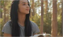 Female Hiker Reads Book At The Forest