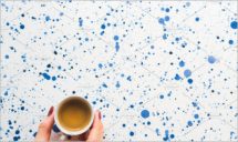 Cup of coffee with woman's hand