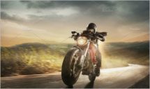 Motorcyclist in black helmet driving