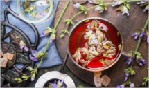 Cup of herbal tea with fresh herbs