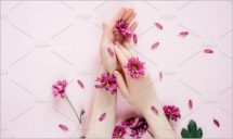 Female hands with purpure flowers