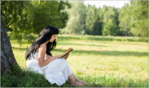 Girl with a book in the forest
